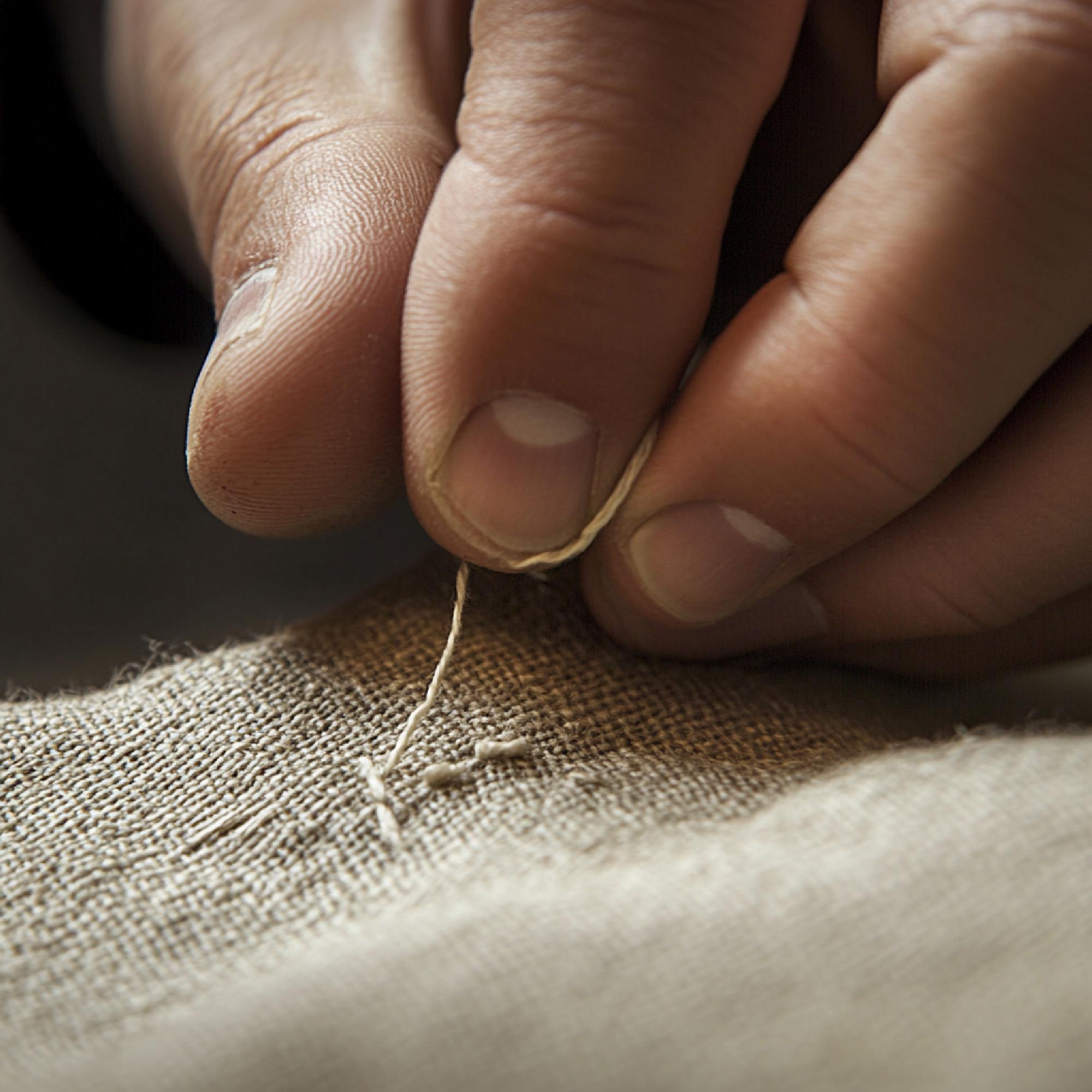 Hand resting on embroidered linen